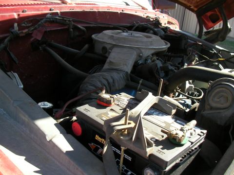 1979 Ford F-350 - The engine bay of a red 1979 Ford F-350 shows its battery and air filter assembly.