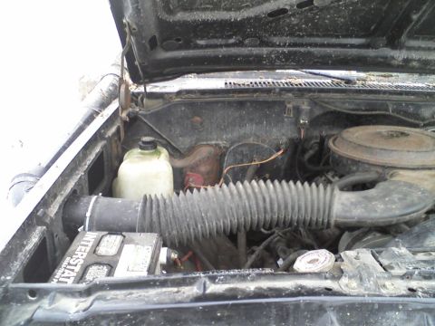 1988 Chevrolet Blazer - Engine bay view of a 1988 Chevrolet Blazer, showing the battery and air intake system.