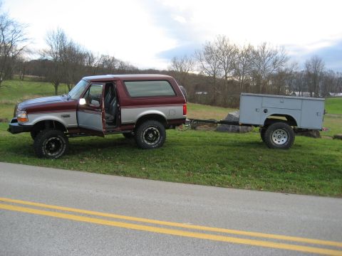 1996 Ford Bronco - This 1996 Ford Bronco is shown in a three-quarter front view, towing a utility trailer.
