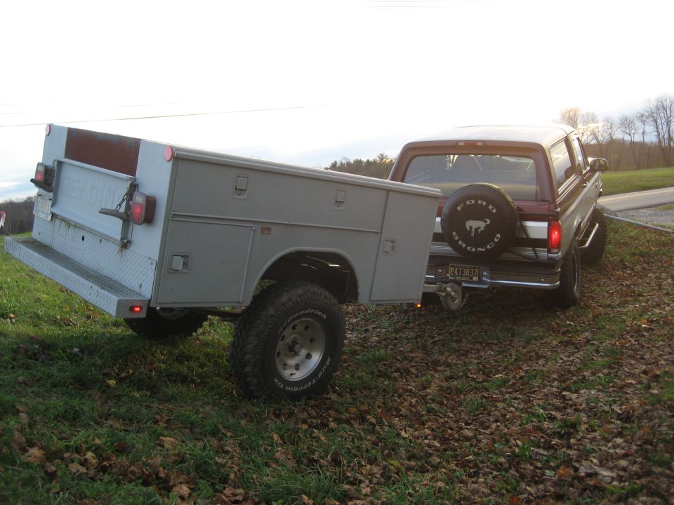1996 Ford Bronco rear view towing utility trailer with spare tire mounted