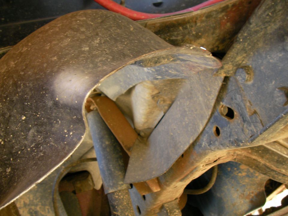 Close-up of a rusty metal suspension component on a vehicle frame