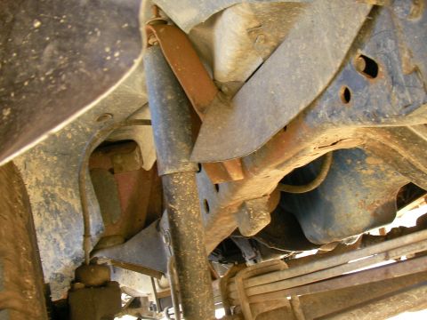 1979 Ford F-350 - The underside of a truck reveals its suspension components and frame, with visible signs of rust and age.