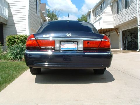 1999 Mercury Grand Marquis - Rear view of a 1999 Mercury Grand Marquis parked on a concrete driveway.