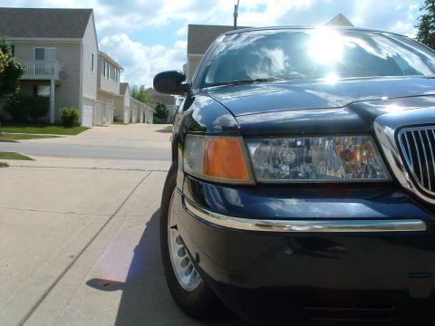 1999 Mercury Grand Marquis - Front corner view of a 1998 Mercury Grand Marquis parked on a suburban driveway.