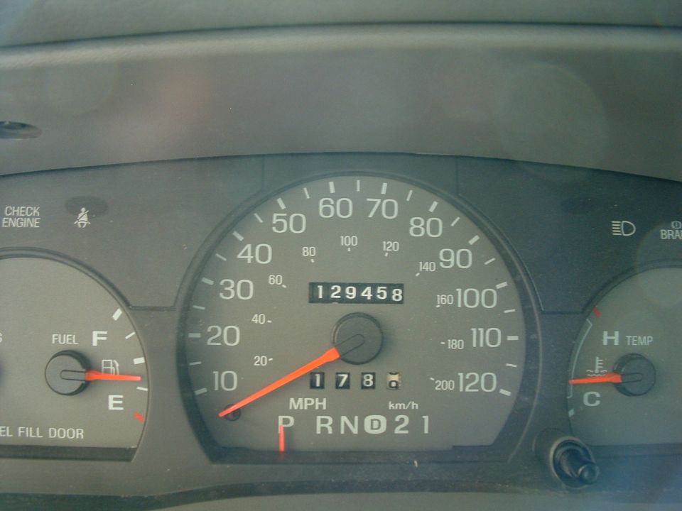 speedometer reads 17 mph, odometer shows 129458 miles, fuel gauge is on E