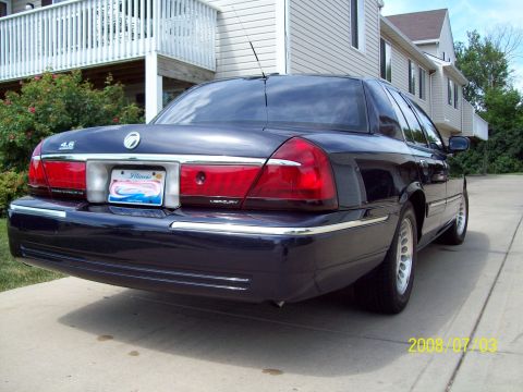 1999 Mercury Grand Marquis - Rear view of a 1999 Mercury Grand Marquis parked on a concrete driveway.