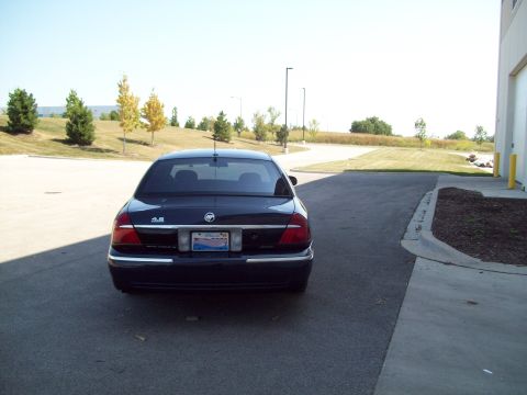 1999 Mercury Grand Marquis - The rear of a 1999 Mercury Grand Marquis is shown parked on asphalt.