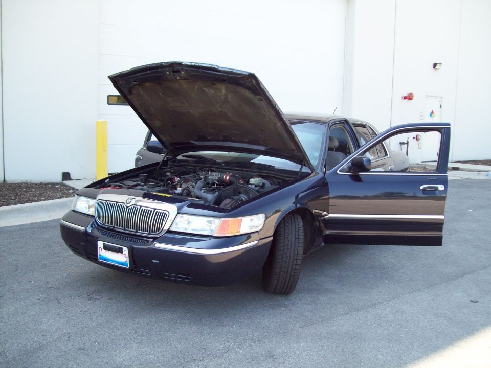 Dark blue 1999 Mercury Grand Marquis with hood and driver's door open