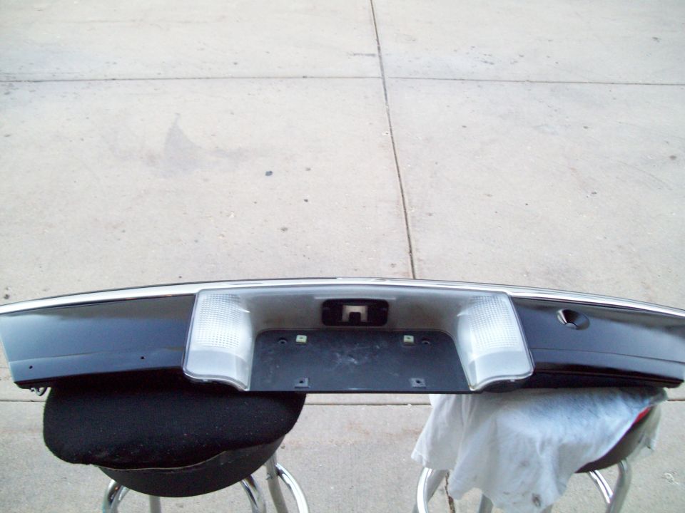 Removed dark blue trunk panel with license plate recess and clear backup lamps on stools