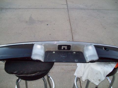 1999 Mercury Grand Marquis - A detached rear bumper section is shown, clear rectangular lights and a central area for a license plate.