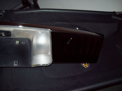 1999 Mercury Grand Marquis - A car taillight assembly with a tinted lens is shown against a black textured background.