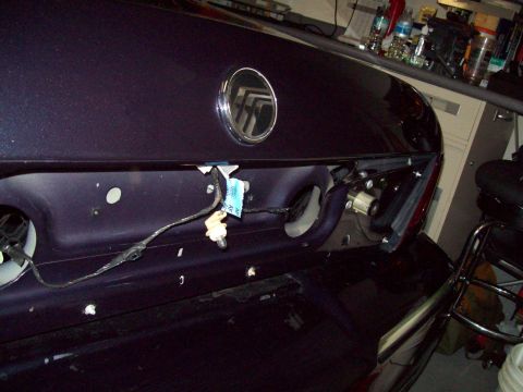 1999 Mercury Grand Marquis - The rear of a 1999 Mercury Grand Marquis shows the emblem and wiring for the taillight assembly.