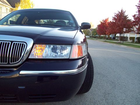 1999 Mercury Grand Marquis - Front corner view of a 1999 Mercury Grand Marquis, its distinctive chrome grille and headlights.