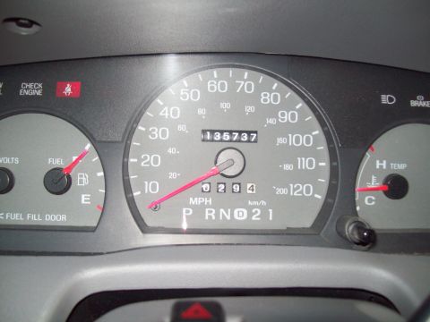 1999 Mercury Grand Marquis - Interior view of a car's dashboard gauges, including the odometer reading 135,737 miles.