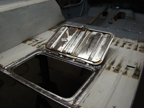 1948 Jeep Wrangler - Close-up of a vehicle's interior floor showing an open access hatch and evidence of recent body work.