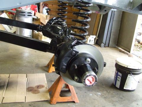 1967 Ford Bronco - Front axle and brake assembly of a Ford Bronco, likely undergoing maintenance or upgrade.