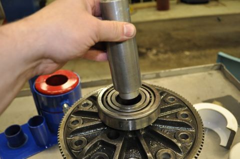1996 Ford Bronco - A tool is used to press a bearing onto a vehicle's differential gear assembly.
