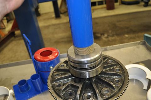 1996 Ford Bronco - A bearing puller tool is shown engaged with a differential gear, likely for removal or installation.