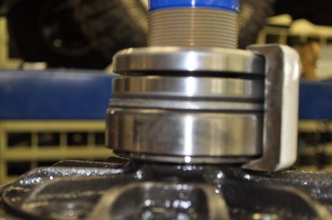 1996 Ford Bronco - Close-up of a bearing puller tool in action on a mechanical component.