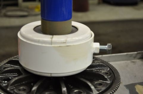 1996 Ford Bronco - A bearing puller tool is positioned over a differential gear assembly.