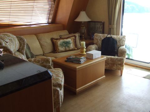 1976 Ford F-150 - Living area with furniture and window blinds, likely on a boat or RV.