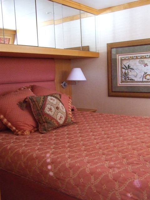 1976 Ford F-150 - A view of a bedroom interior, a bed with decorative pillows and a framed picture on the wall.