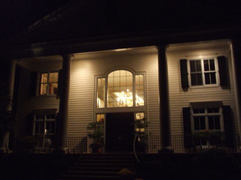 1976 Ford F-150 - Exterior of a house at night, illuminated by exterior lights.
