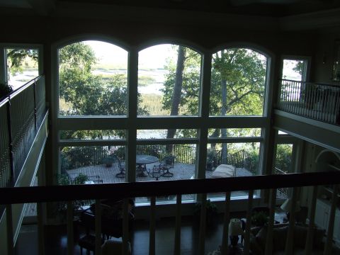 1976 Ford F-150 - Interior of a home with a large window overlooking a scenic waterfront view and outdoor deck.