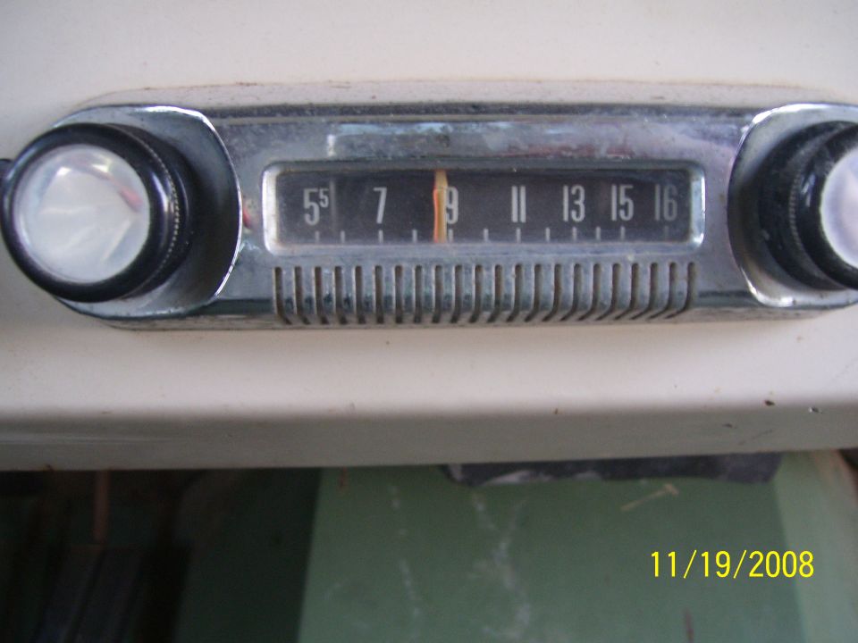 Vintage car radio with tuning dial showing 55, 7, 9, 11, 13, 15, 16