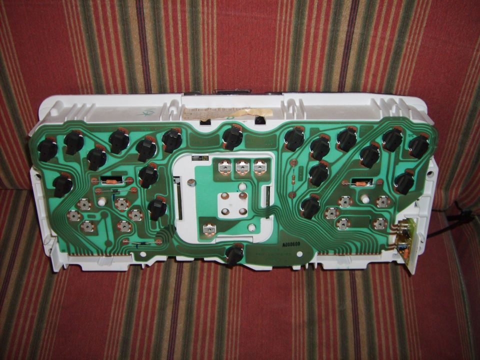 Back of a car's instrument cluster showing the circuit board and electrical connections
