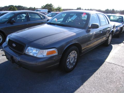 2001 Ford Crown Victoria - Dark gray 2001 Ford Crown Victoria sedan parked outdoors. Other vehicles visible in background.