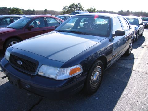 2001 Ford Crown Victoria - This 2001 Ford Crown Victoria police car is seen in a parking lot with other vehicles.