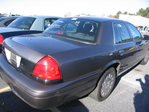 2001 Ford Crown Victoria - This 2001 Ford Crown Victoria is seen from a 3q front angle, with visible text on the rear window.