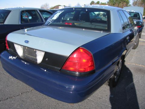 2001 Ford Crown Victoria - Rear view of a two-tone blue and grey 2001 Ford Crown Victoria sedan parked outdoors.