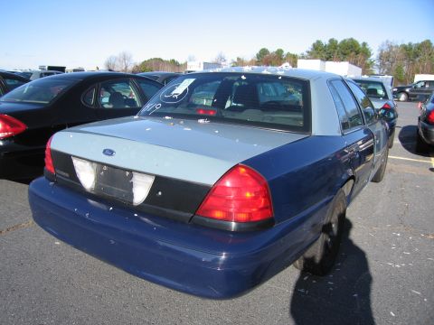 2001 Ford Crown Victoria - This 2001 Ford Crown Victoria is parked in an outdoor lot with several other vehicles visible.