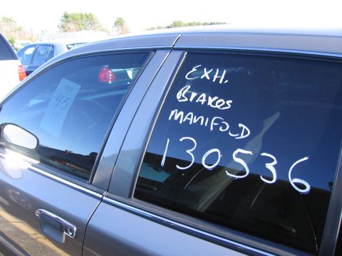 2001 Ford Crown Victoria - Car window displays handwritten text and a numerical identifier, with another vehicle visible in the background.