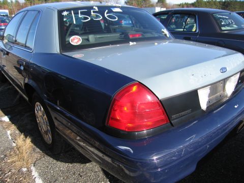 2001 Ford Crown Victoria - Rear view of a 2001 Ford Crown Victoria with #1556 on the window. Another vehicle is visible behind.
