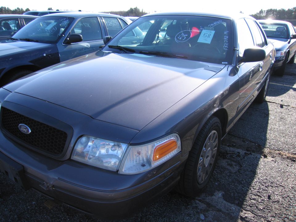 Dark gray 2001 Ford Crown Victoria front quarter view with other cars in background