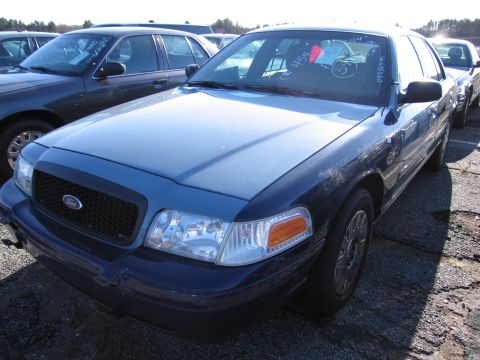 2001 Ford Crown Victoria - Blue 2001 Ford Crown Victoria in a parking lot with other vehicles.