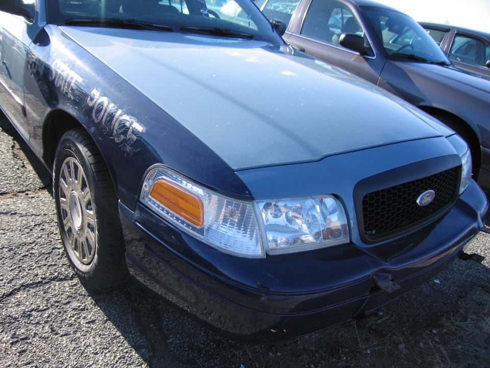 2001 Ford Crown Victoria police car front fender with STATE POLICE text, grille, and headlight