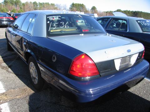2001 Ford Crown Victoria - Rear view of a 2001 Ford Crown Victoria with blue and silver two-tone paint. "1536" is written on the rear window.