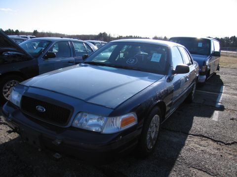 2001 Ford Crown Victoria - Front 3/4 view of a blue 2001 Ford Crown Victoria in an outdoor lot.