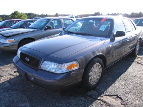 2001 Ford Crown Victoria - Dark gray 2001 Ford Crown Victoria sedan parked outdoors with other vehicles.