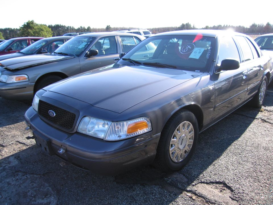 2001 Ford Crown Victoria front 3/4 view, parked in lot with other cars