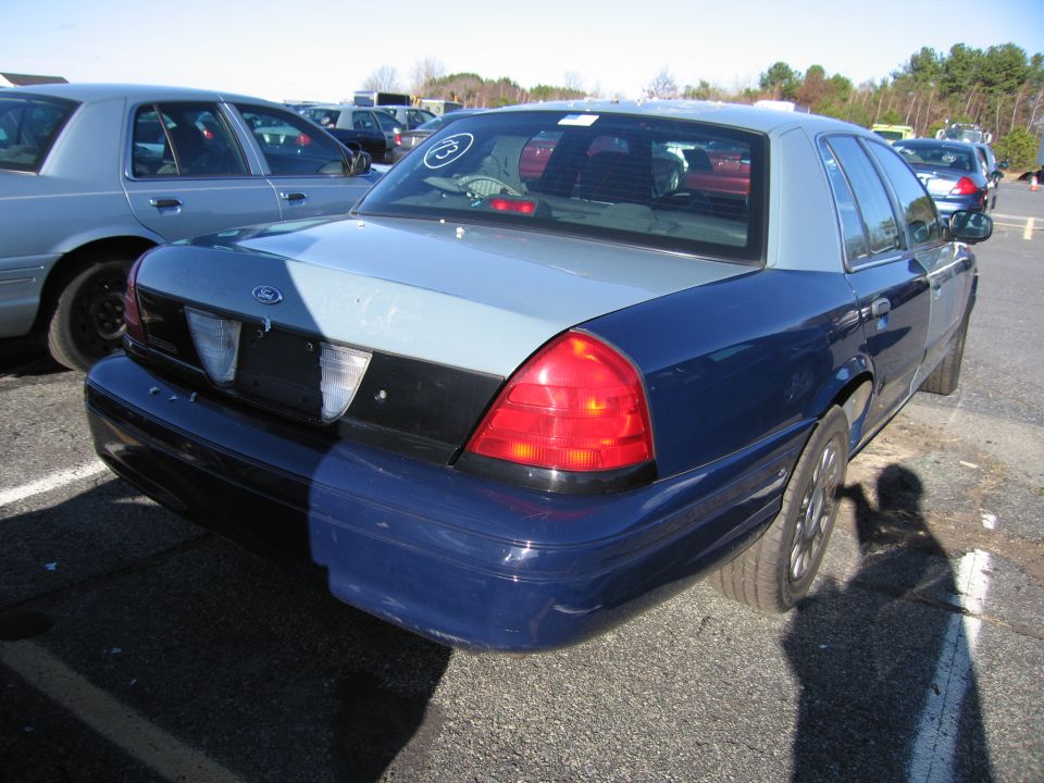2001 Ford Crown Victoria rear quarter view, parked in lot with other vehicles
