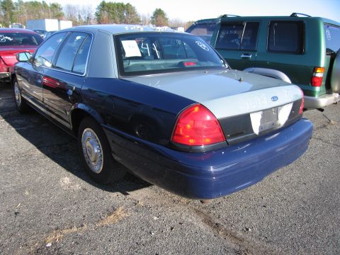 2001 Ford Crown Victoria - This 2001 Ford Crown Victoria sedan features a two-tone paint scheme with a dark blue lower body and a light gray upper body.