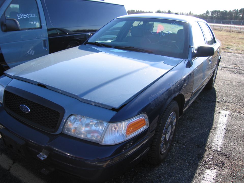 Blue Ford Crown Victoria, 3q-front view. Hood is open