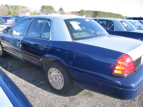 2001 Ford Crown Victoria - Side view of a two-tone blue and silver 2001 Ford Crown Victoria in an outdoor lot.