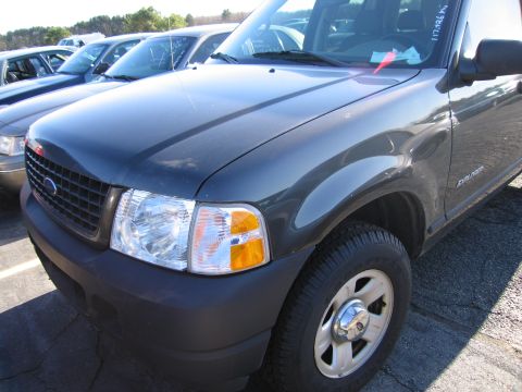 2001 Ford Crown Victoria - Front corner of a dark gray SUV, possibly a Ford Explorer, with visible text on the windshield.