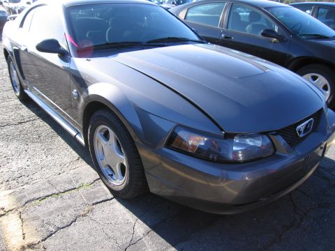 2001 Ford Crown Victoria - Front view of a gray Ford Mustang, showing the headlight and grille detail.